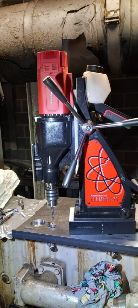 Precision in-situ drilling to remove seized hardened dowel from engine block without damaging surrounding components.